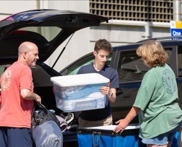 student unloading car